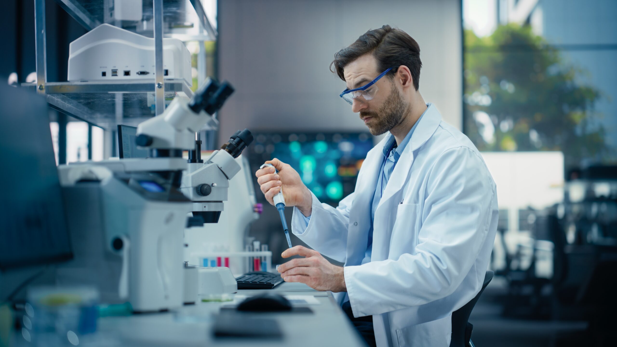 Scientist in laboratory working with digital microscope